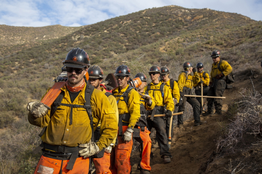 In this undated image provided by the Forestry and Fire Recruitment Program, firefighters from the Forestry and Fire Recruitment Program in pause the Angeles National Forest near Los Angeles. The Forestry and Fire Recruitment Program, a nonprofit, has a $3.4 million budget and has trained more than 3,000 people and helped more than 140 get jobs.