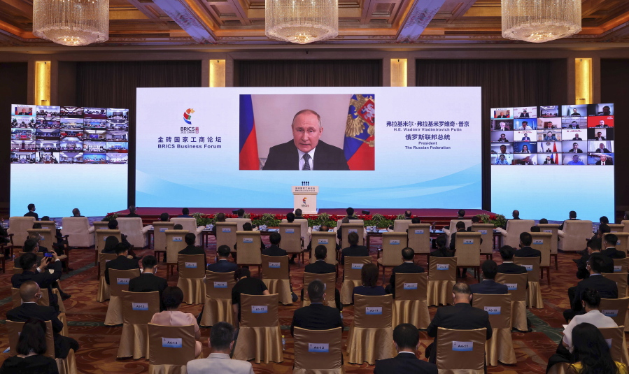 In this photo released by Xinhua News Agency, Russian President Vladimir Putin delivers a keynote speech in virtual format at the opening ceremony of the BRICS Business Forum in Beijing Wednesday, June 22, 2022. The conflict in Ukraine has "sounded an alarm for humanity," Chinese leader Xi Jinping said Wednesday, as China continues to assume a position of neutrality while backing its ally Russia.