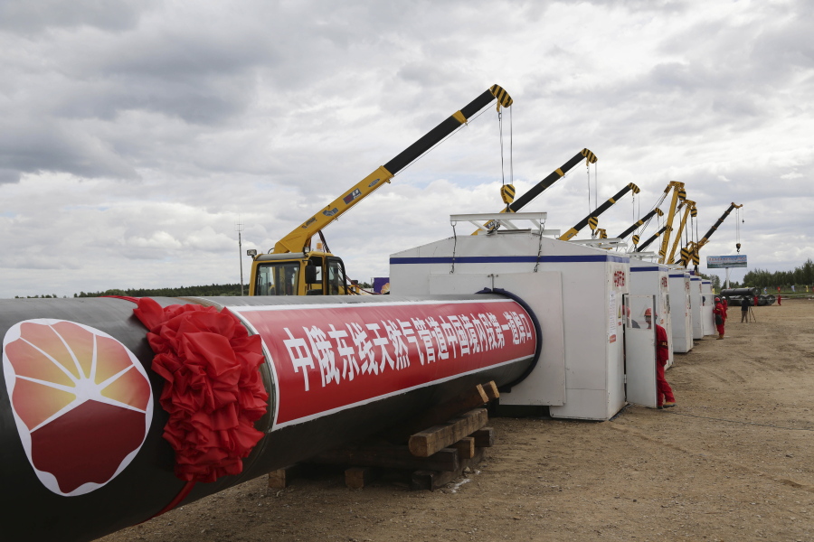 FILE - Workers gather during a ceremony to start construction of the China-Russia East Route natural gas pipeline, also known as the Power of Siberia trunk pipeline, in Heihe in northeastern China's Heilongjiang Province on June 29, 2015. China's support for Russia through oil and gas purchases is irking Washington and raising the risk of U.S. retaliation, foreign observers say, though they see no sign Beijing is helping Moscow evade sanctions over its war on Ukraine.
