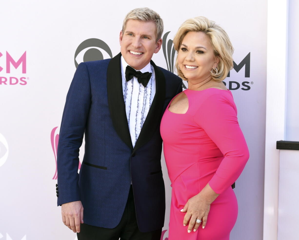 FILE - Todd Chrisley, left, and his wife, Julie Chrisley, pose for photos at the 52nd annual Academy of Country Music Awards on April 2, 2017, in Las Vegas. The couple, stars of the reality television show "Chrisley Knows Best," have been found guilty in Atlanta on federal charges including bank fraud and tax evasion Tuesday, June 7, 2022.