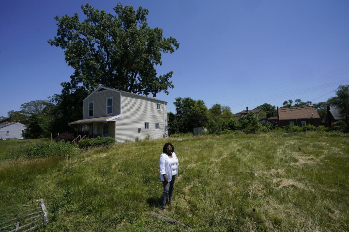 Donele Wilkins, founder of Green Door Initiative, a group that does environmental workforce development, stands in the field next to her childhood home where her company is developing a solar community hub, Tuesday, June 28, 2022, in Detroit. Fourteen smaller environmental justice organizations from around the United States, including Green Door Initiative, have begun to receive money under the Justice40 initiative to improve the environment in disadvantaged communities and help them prepare for climate change.