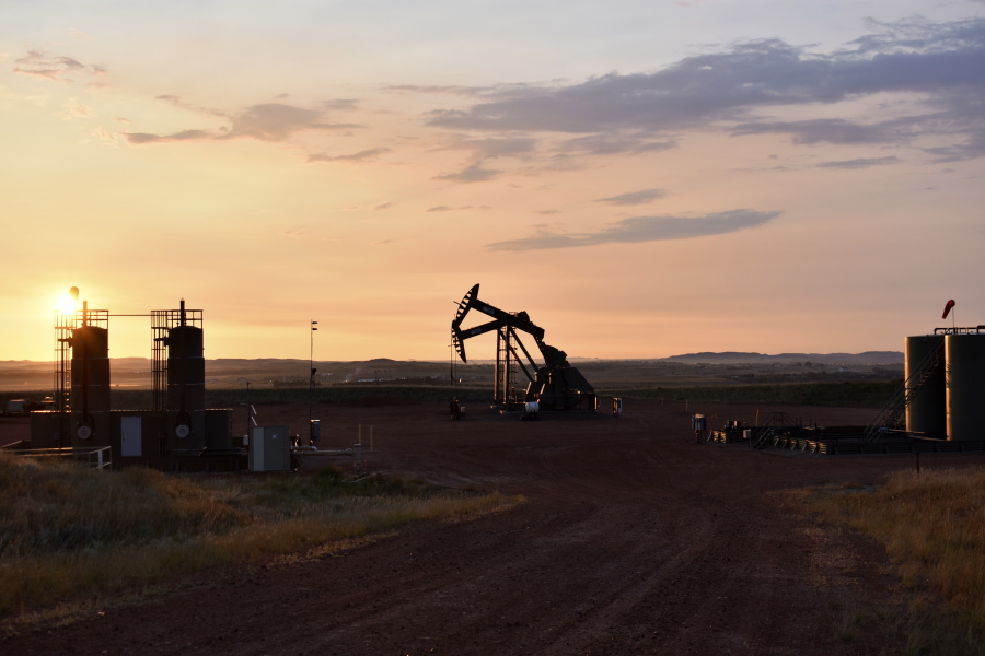 FILE - An oil well works at sunrise Aug. 25, 2021, in Watford City, N.D., part of McKenzie County. U.N. Secretary-Antonio Guterres warned Tuesday, June 14, of a "dangerous disconnect" between what scientists and citizens are demanding to curb climate change, and what governments are actually doing about it. Guterres said the war in Ukraine risked worsening the crisis, because major economies were "doubling down on fossil fuels" that are to blame for much of the emissions stoking global warming.