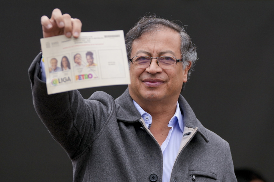 Gustavo Petro, presidential candidate with the Historical Pact coalition, shows his ballot before voting in a presidential runoff in Bogota, Colombia, Sunday, June 19, 2022.