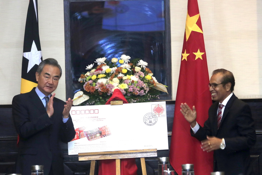 Chinese Foreign Minister Wang Yi, left, and East Timorese Prime Minister Taur Matan Ruak applaud during their meeting in Dili, East Timor, Friday, June 3, 2022.