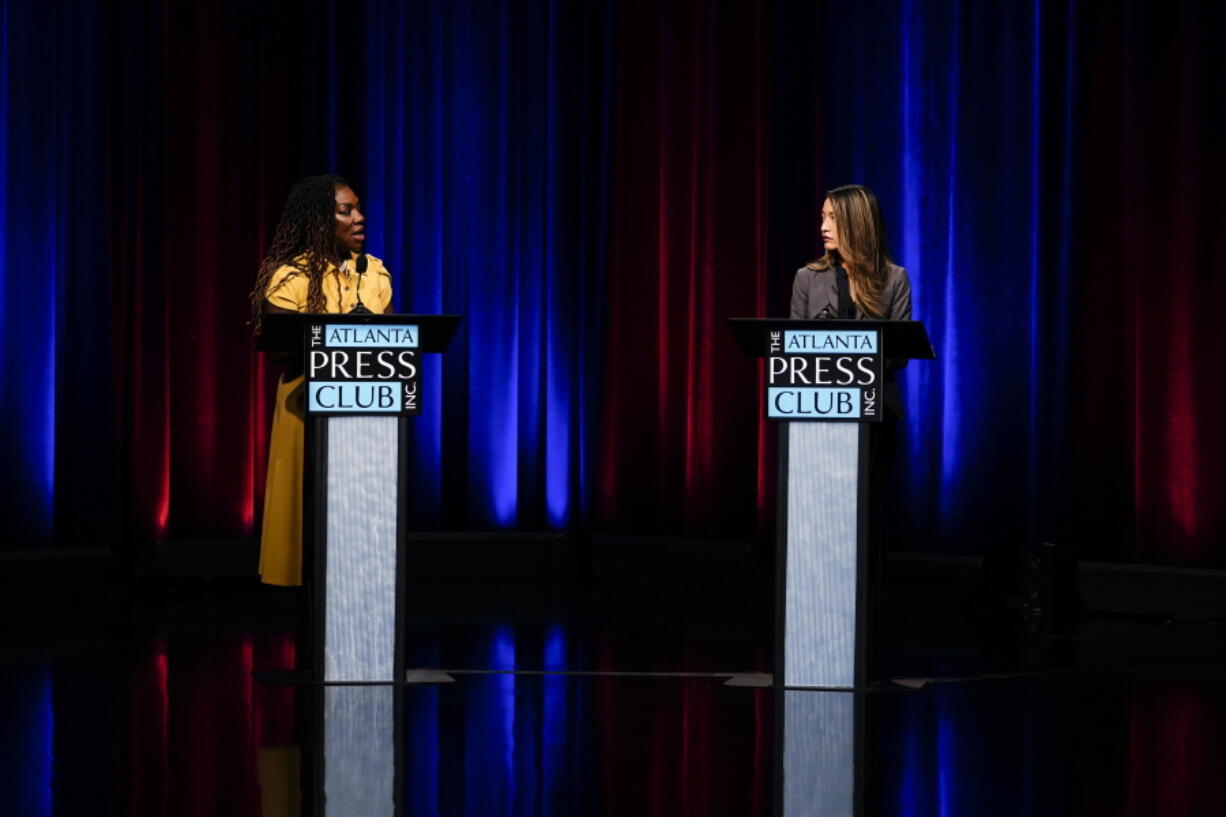 Former state Rep. Dee Dawkins-Haigler, left, and Georgia State Rep. Bee Nguyen, right, participate in Georgia's secretary of state democratic primary election runoff debates on Monday, June 6, 2022, in Atlanta.