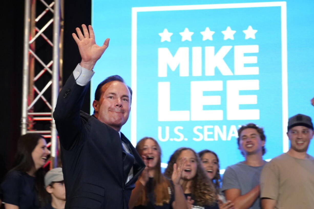 Sen. Mike Lee, R-Utah, walks out with his family in the background to declare victory to supporters during a Utah Republican primary-night party Tuesday, June 28, 2022, in South Jordan, Utah. Lee defeated two challengers in the primary.