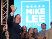 Sen. Mike Lee, R-Utah, walks out with his family in the background to declare victory to supporters during a Utah Republican primary-night party Tuesday, June 28, 2022, in South Jordan, Utah. Lee defeated two challengers in the primary.