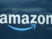 FILE - An Amazon logo appears on a delivery van, Oct. 1, 2020, in Boston. Amazon is limiting how many emergency contraceptives consumers can buy, joining other retailers who put in place similar caps following the Supreme Court decision overruling Roe v. Wade. Amazon's limit, which temporarily caps purchase of the contraceptives at three units per week, went into effect on Monday, June 27, 2022, a spokesperson for the e-commerce giant confirmed to the Associated Press.