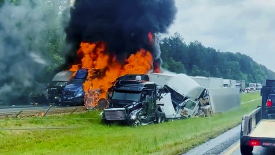 In this image taken from video flames and smoke billow from trucks involved in a deadly multiple vehicle crash along Interstate 30 in southwestern Arkansas, Wednesday, June 8, 2022.