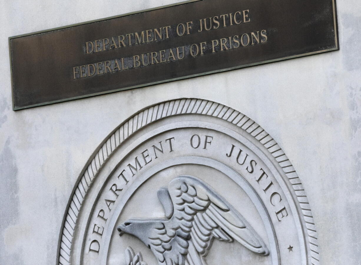 A sign for the Department of Justice Federal Bureau of Prisons is displayed at the Metropolitan Detention Center in the Brooklyn borough of New York. Colette Peters, who runs Oregon's prison system, has emerged as the leading contender to run the federal prison system.