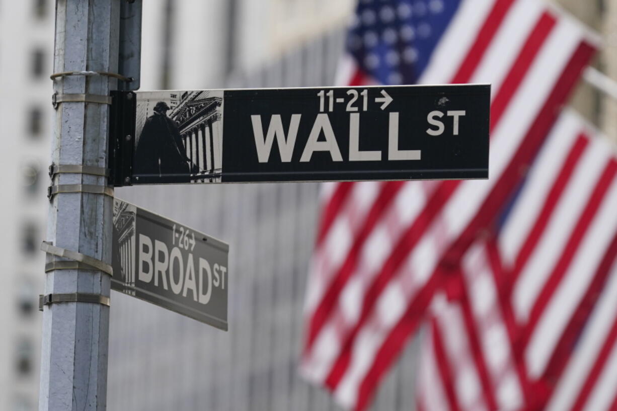 FILE - A street sign is seen in front of the New York Stock Exchange in New York, Tuesday, June 14, 2022. Stocks are opening broadly higher on Wall Street Tuesday, June 21, clawing back some of the ground they lost in their worst weekly drop since the beginning of the pandemic.
