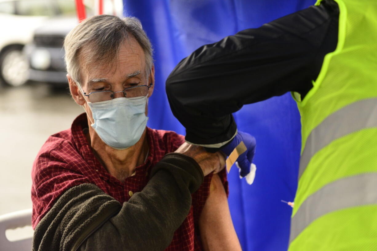 FILE - Crager Boardman, from Brattleboro, Vt., receives a shot at a flu vaccine clinic in Brattleboro on Tuesday, Oct. 26, 2021. On Wednesday, June 22, 2022, a federal advisory panel says Americans 65 and older should get newer, souped-up flu vaccines. The panel unanimously recommended certain flu vaccines for seniors, whose weakened immune systems don't respond as well to traditional shots.