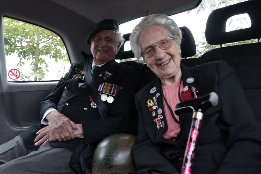 British veterans Roy Maxwell and Mary Scott arrive in a British Taxi Charity for Military Veterans to the ceremony at Pegasus Bridge, in Ranville, Normandy, Sunday, June, 5, 2022. On Monday, the Normandy American Cemetery and Memorial, home to the gravesites of 9,386 who died fighting on D-Day and in the operations that followed, will host U.S. veterans and thousands of visitors in its first major public ceremony since 2019.
