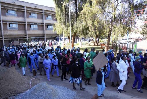 FILE -Health workers led by nurses take part in a demonstration over salaries at Parerenyatwa Hospital in Harare, on June, 21, 2022. As food costs and fuel bills soar, inflation is plundering people's wallets, sparking a wave of protests and workers' strikes around the world.