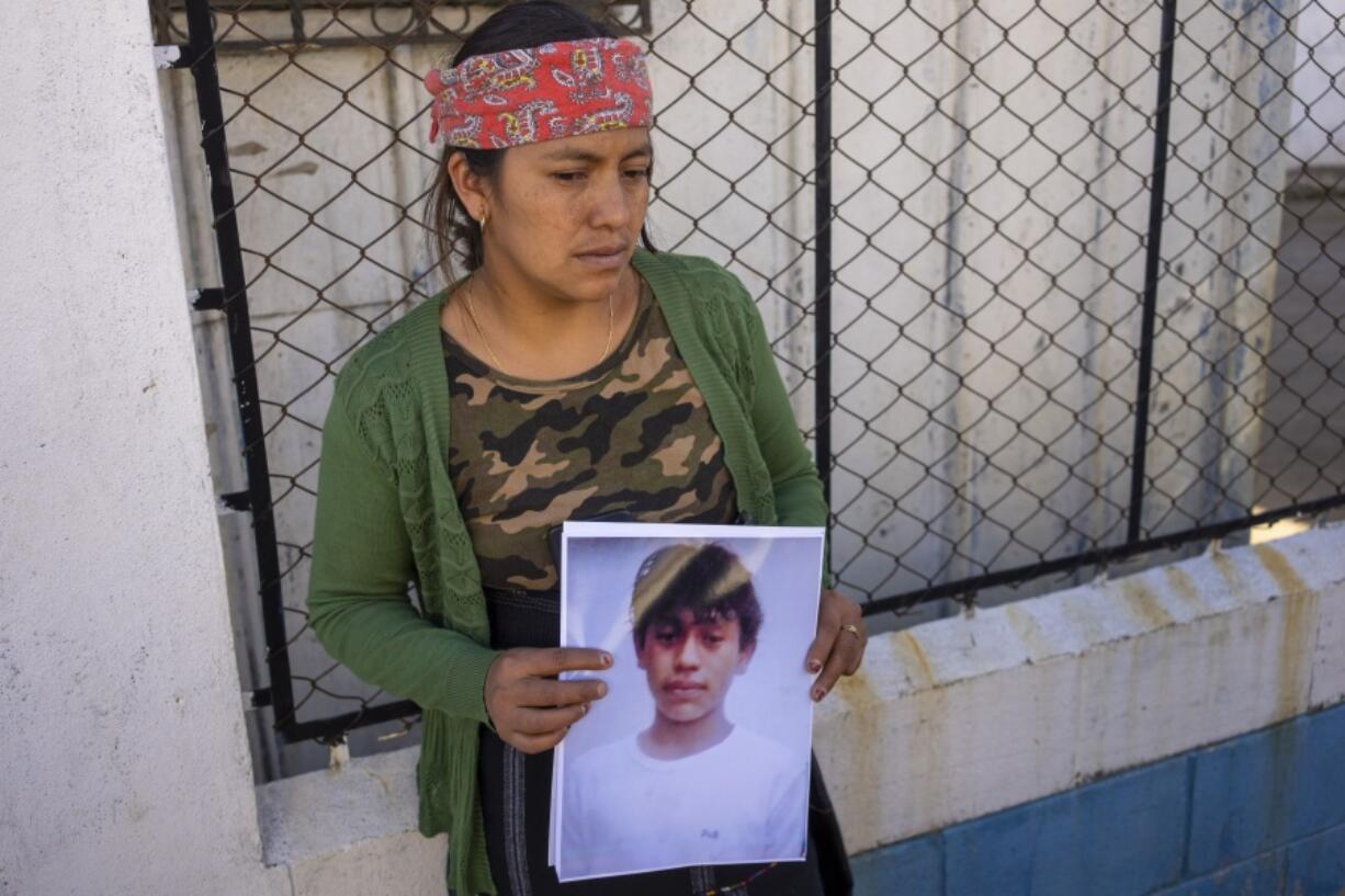 Maria Sipac Coj holds a portrait of her son Pascual Melvin Guachiac in Tzucubal, Guatemala, Wednesday, June 29, 2022. Pascual and his cousin Wilmer Tulul, both 13, were among the dead discovered inside a tractor-trailer near auto salvage yards on the edge of San Antonio, Texas, on Monday, in what is believed to be the nation's deadliest smuggling episode on the U.S.-Mexico border.