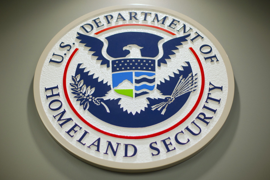 FILE - The Department of Homeland Security logo is seen during a news conference in Washington, Feb. 25, 2015. DHS says a looming Supreme Court decision on abortion, an increase of migrants at the U.S.-Mexico border and the midterm elections are potential triggers for extremist violence over the next six months. DHS said June 7, 2022, in the National Terrorism Advisory System bulletin the U.S. was in a "heightened threat environment" already and these factors may worsen the situation.