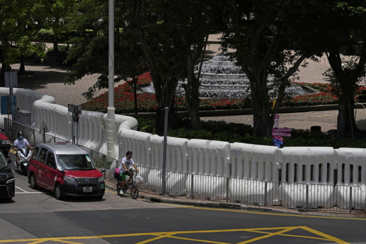 Water-filled barriers have been installed by police outside the Hong Kong Convention and Exhibition Centre where the inauguration ceremony of the newly-appointed Chief Executive John Lee will take place in Hong Kong, Monday, June 27, 2022. Questions continue to circle over whether Chinese leader Xi Jinping will attend the 25th year anniversary of Hong Kong's handover from British to Chinese rule and the inauguration of of the territory's new leader.
