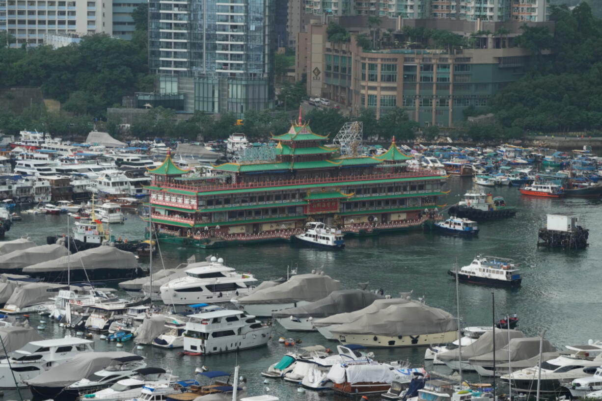 Hong Kong's iconic Jumbo Floating Restaurant is towed away in Hong Kong, Tuesday, June 14, 2022. Hong Kong's iconic restaurant on Tuesday departed the city, after its parent company failed to find a new owner and lacked funds to maintain the establishment amid months of COVID-19 restrictions.