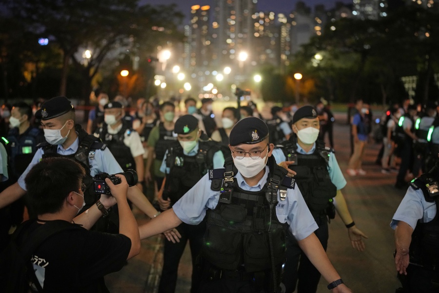 Police officers stop people entering the Hong Kong's Victoria Park, Saturday, June 4, 2022. Heavy police force patrolled Hong Kong's Victoria Park on Saturday after authorities for a third consecutive year banned public commemoration of the anniversary of the deadly Tiananmen Square crackdown in 1989, with vigils overseas the only place marking the event.