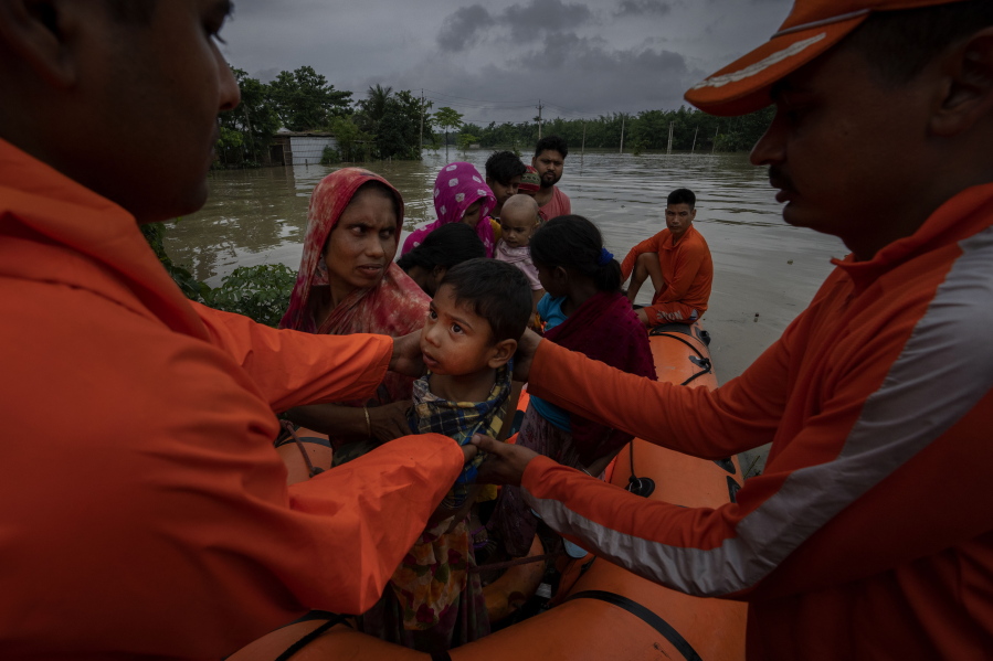 National Disaster Response Force (NDRF) personnel rescue flood-affected villagers in Korora village, west of Gauhati, India, Friday, June 17, 2022.