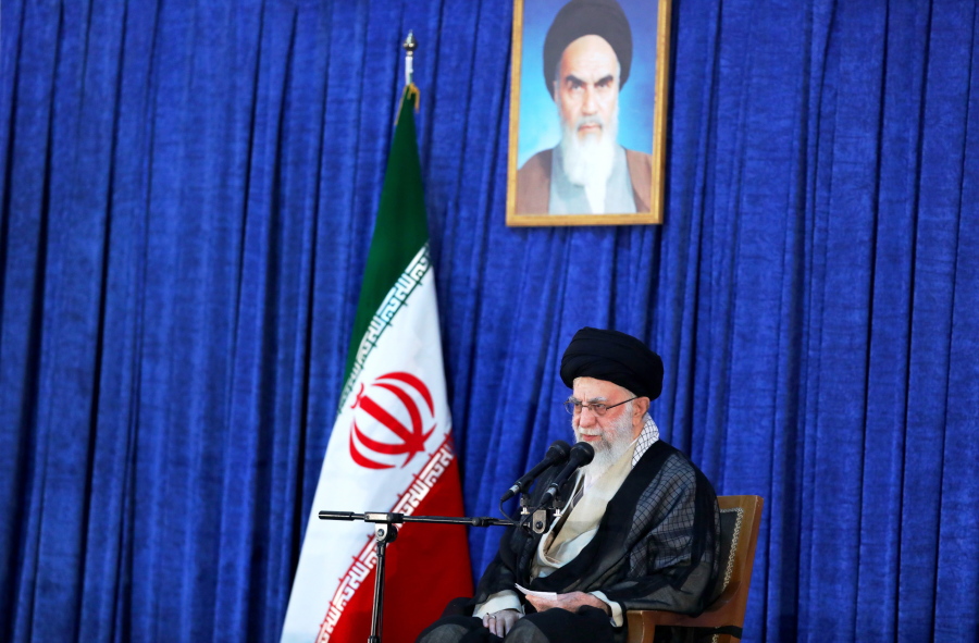 In this photo released by an official website of the office of the Iranian supreme leader, Supreme Leader Ayatollah Ali Khamenei speaks on the anniversary of the death of the late founder of the Islamic Republic, Ayatollah Ruhollah Khomeini, shown in the poster at top center, at his mausoleum in Tehran, Iran, Saturday, June 4, 2022. Khamenei acknowledged Saturday that Iran took the oil from two Greek tankers last month in helicopter-launched raids in the Persian Gulf.