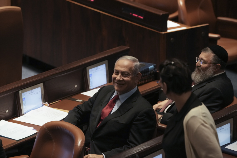 Former Israeli Prime Minister Benjamin Netanyahu smiles during a preliminary vote on a bill to dissolve parliament, at the Knesset, Israel's parliament, in Jerusalem, Wednesday, June 22, 2022. Israeli lawmakers voted in favor of dissolving parliament in a preliminary vote, setting the wheels in motion to send the country to its fifth national election in just over three years.