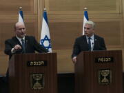 Israeli Prime Minister Naftali Bennett, left, speaks during a joint statement with Foreign Minister Yair Lapid, at the Knesset, Israel's parliament, in Jerusalem, Monday, June 20, 2022. Bennett's office announced Monday, that his weakened coalition will be disbanded and the country will head to new elections. Bennett and his main coalition partner, Yair Lapid, decided to present a vote to dissolve parliament in the coming days, Bennett's office said. Lapid is then to serve as caretaker prime minister. The election, expected in the fall, would be Israel's fifth in three years.
