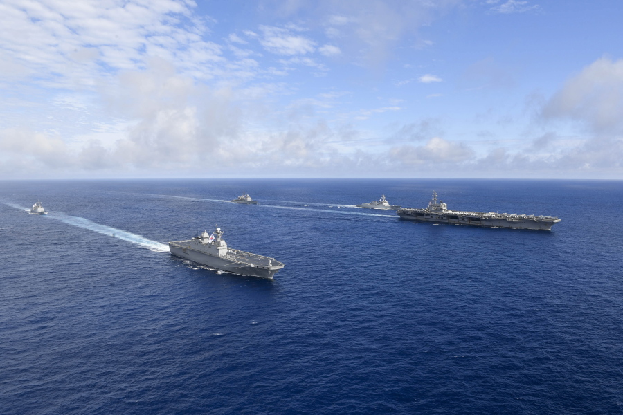 In this photo provided by South Korea's Defense Ministry, U.S. nuclear-powered aircraft carrier USS Ronald Reagan, right, and South Korea's landing platform helicopter (LPH) ship Marado, second from left, sail during a joint military exercise at an undisclosed location, Saturday, June 4, 2022.