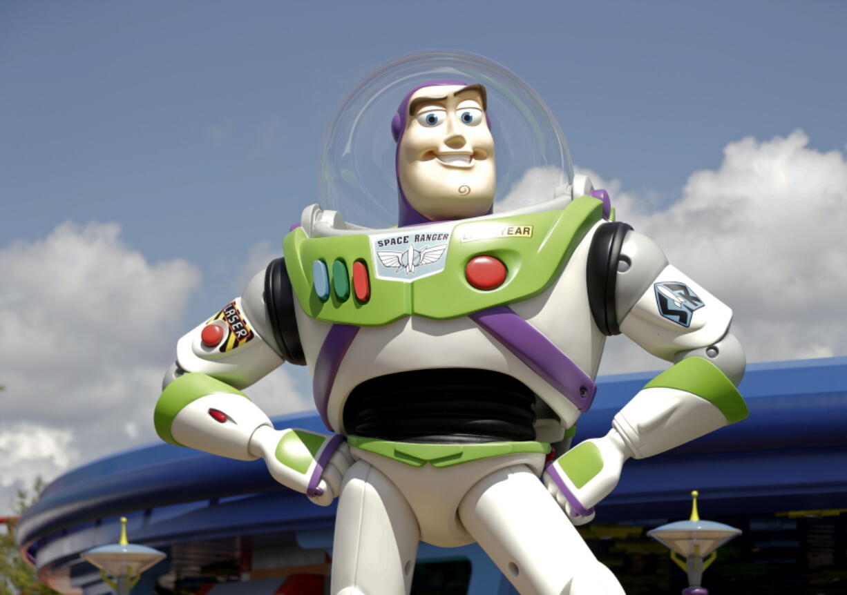 FILE - Character Buzz Lightyear stands near the entrance to the Aliens Swirling Saucers ride at Toy Story Land in Disney's Hollywood Studios at Walt Disney World in Lake Buena Vista, Fla., June 23, 2018. Malaysia's film censors said Friday, June 17, 2022, that it was Disney's decision to ax the animated film "Lightyear" from the country's cinemas after refusing to cut scenes promoting homosexuality.