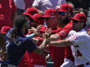 Seattle Mariners' J.P. Crawford, left, and several members of the Los Angeles Angels scuffle after Mariners' Jesse Winker was hit by a pitch during the second inning of a baseball game Sunday, June 26, 2022, in Anaheim, Calif. (AP Photo/Mark J. Terrill) (Mark J.