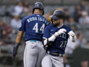 Seattle Mariners' Jesse Winker celebrates with Julio Rodriguez, left, after hitting a two-run home run against the Oakland Athletics during the fifth inning of a baseball game in Oakland, Calif., Wednesday, June 22, 2022.