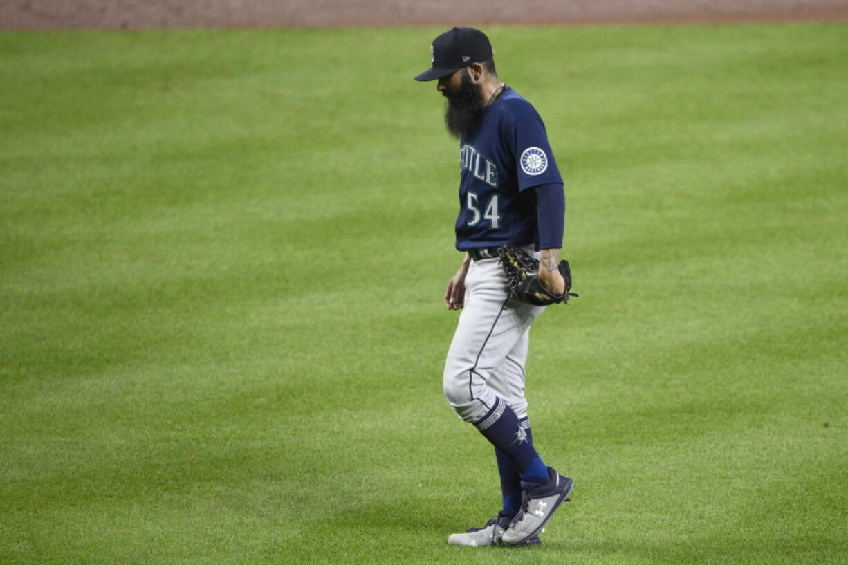 Seattle Mariners relief pitcher Sergio Romo walks back to the dugout after he was pulled during the sixth inning of the team's baseball game against the Baltimore Orioles, Wednesday, June 1, 2022, in Baltimore.
