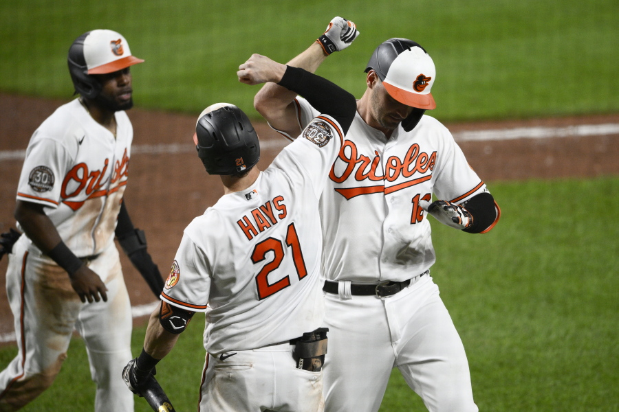 Baltimore Orioles' Trey Mancini, right, celebrates his two-run home run with Austin Hays (21) and Cedric Mullins, left, during the sixth inning of the team's baseball game against the Seattle Mariners, Wednesday, June 1, 2022, in Baltimore.