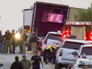 Police and other first responders work the scene where officials say dozens of people have been found dead and multiple others were taken to hospitals with heat-related illnesses after a semitrailer containing suspected migrants was found, Monday, June 27, 2022, in San Antonio.