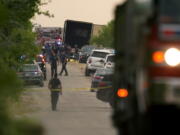 Body bags lie at the scene where a tractor trailer with multiple dead bodies was discovered, Monday, June 27, 2022, in San Antonio.