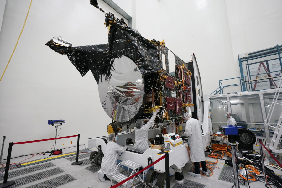 FILE - Technicians work on the Psyche spacecraft at the NASA Jet Propulsion Laboratory, April 11, 2022, in Pasadena, Calif. NASA put an asteroid mission on hold Friday, June 24, 2022, blaming the late delivery of its own navigation software. The Psyche mission to a strange metal asteroid of the same name was supposed to launch this September or October. But the agency's Jet Propulsion Lab was several months late writing and delivering its software for navigation, guidance and control.