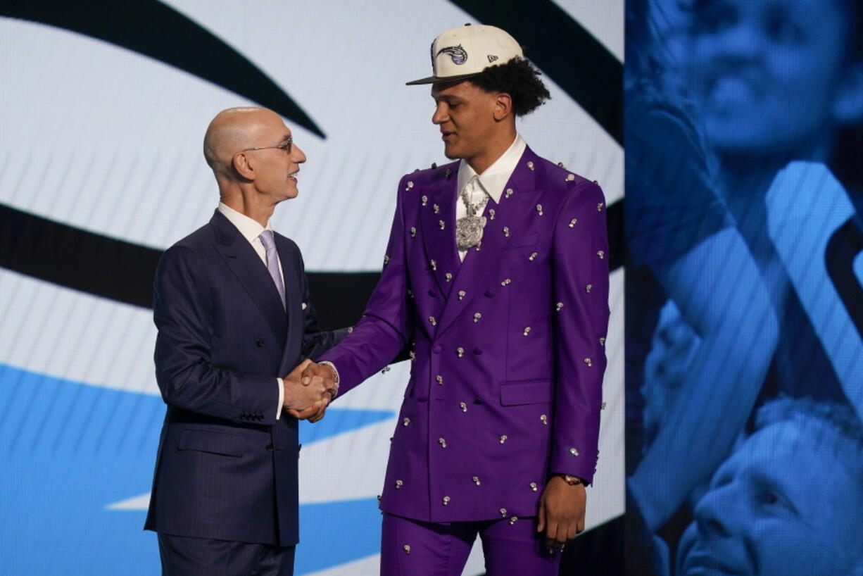 Paolo Banchero, right, is congratulated by NBA Commissioner Adam Silver after being selected as the number one pick overall by the Orlando Magic in the NBA basketball draft, Thursday, June 23, 2022, in New York.