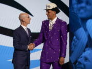 Paolo Banchero, right, is congratulated by NBA Commissioner Adam Silver after being selected as the number one pick overall by the Orlando Magic in the NBA basketball draft, Thursday, June 23, 2022, in New York.