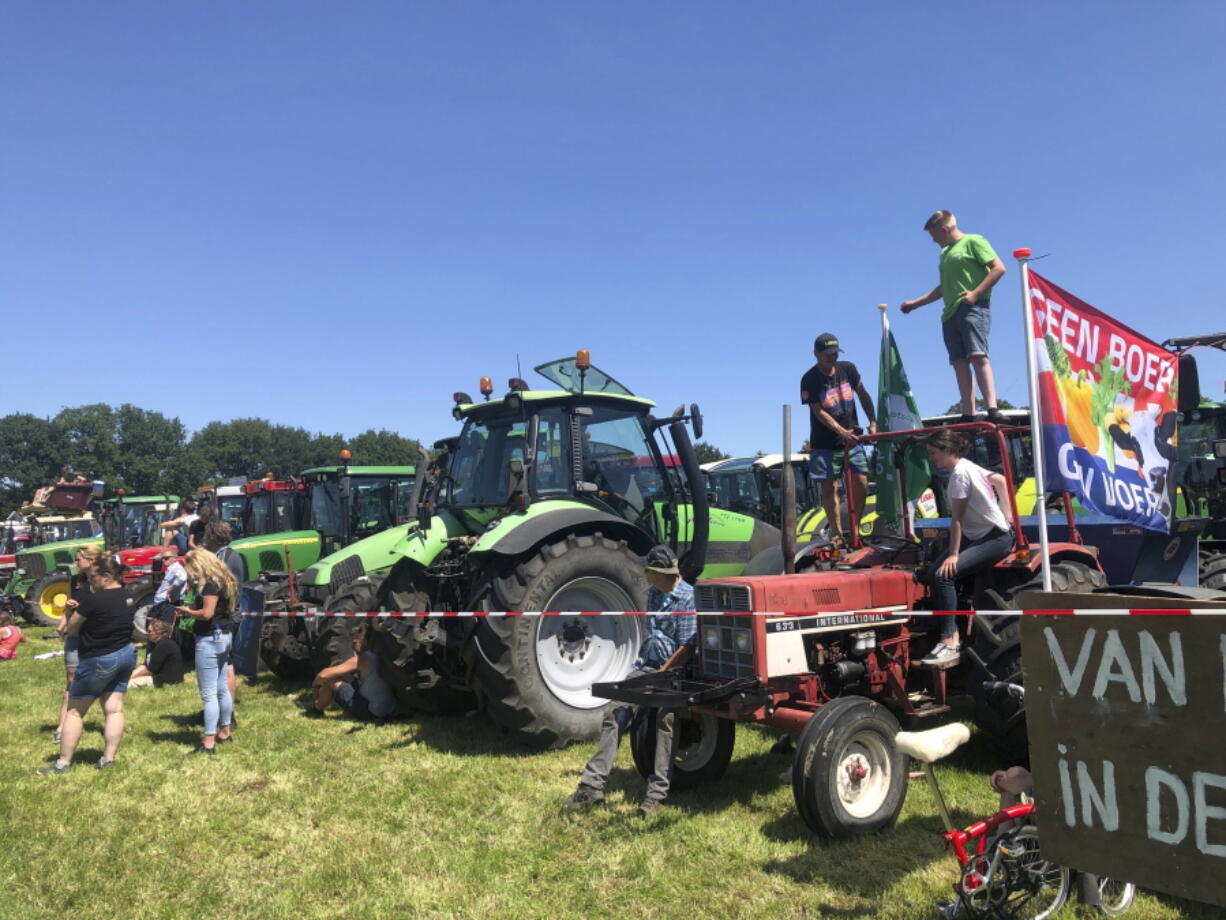 Dutch farmers protesting against the government's plans to reduce emissions of nitrogen oxide and ammonia gather for a demonstration at Stroe, Netherlands, Wednesday, June 22, 2022. Thousands of farmers drove  their tractors along roads and highways across the Netherlands, heading for a mass protest against the Dutch government's plans to rein in emissions of nitrogen oxide and ammonia.