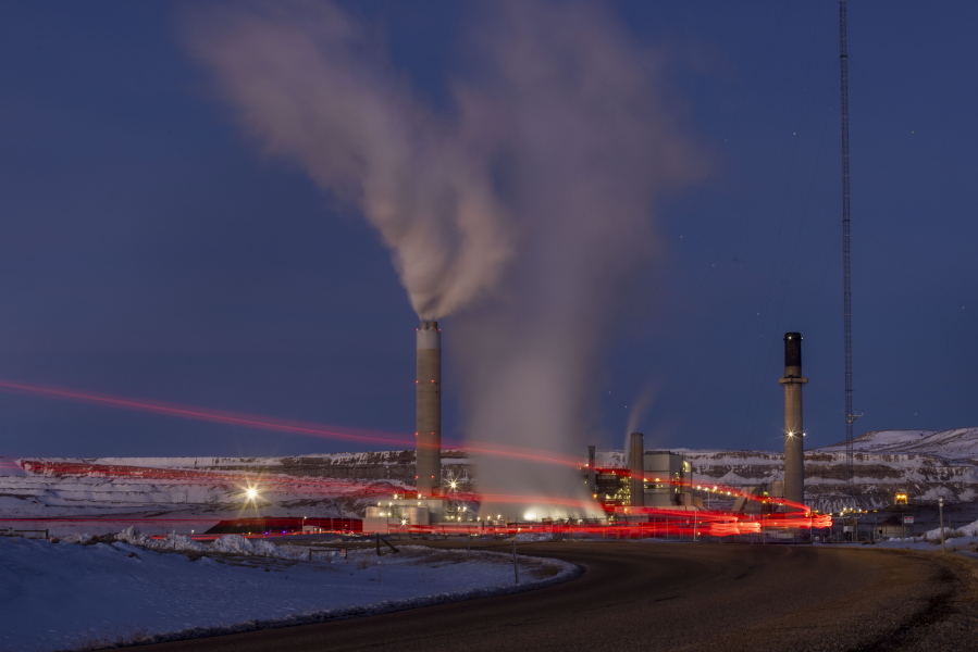 FILE - In this photo taken with a slow shutter speed, taillights trace the path of a motor vehicle at the Naughton Power Plant, Thursday, Jan. 13, 2022, in Kemmerer, Wyo. While the power plant will be closed in 2025, Bill Gates' company TerraPower announced it had chosen Kemmerer for a nontraditional, sodium-cooled nuclear reactor that will bring on workers from a local coal-fired power plant scheduled to close soon. The U.S. nuclear industry has provided a steady 20% of the nation's power for years, but now plant operators are hoping to nearly double their output over the next three decades, according to the industry's trade association.
