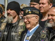 World War II veteran Hershel "Woody" Williams, center, stands with fellow Marines at the Charles E. Shelton Freedom Memorial at Smothers Park on April 6, 2019, in Owensboro, Ky.