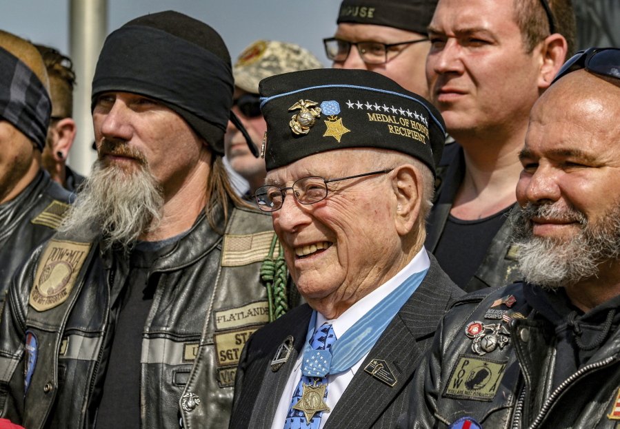 World War II veteran Hershel "Woody" Williams, center, stands with fellow Marines at the Charles E. Shelton Freedom Memorial at Smothers Park on April 6, 2019, in Owensboro, Ky.
