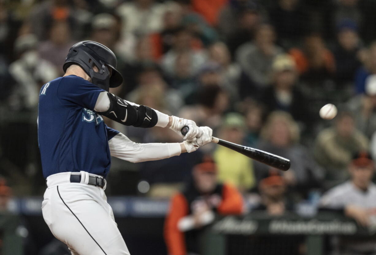 Seattle Mariners' Jessie Winker hits a two-run double off Baltimore Orioles relief pitcher Felix Bautista during the eighth inning of a baseball game Tuesday, June 28, 2022, in Seattle.