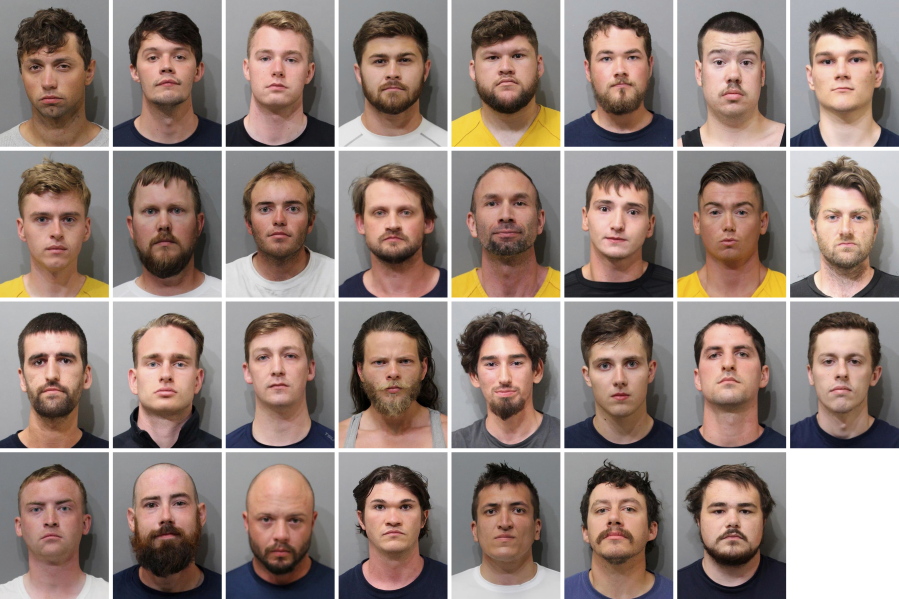 These booking images provided by the Kootenai County Sheriff's Office show the 31 members of the white supremacist group Patriot Front who were arrested after they were found packed into the back of a U-Haul truck with riot gear near an LGBTQ pride event in Coeur d'Alene, Idaho, on Saturday, June 11, 2022. Top row, from left, are Jared Boyce, Nathan Brenner, Colton Brown, Josiah Buster, Mishael Buster, Devin Center, Dylan Corio, and Winston Durham. Second row, from left, are Garret Garland, Branden Haney, Richard Jessop, James Julius Johnson, James Michael Johnson, Connor Moran, Kieran Morris and Lawrence Norman. Third row, from left, are Justin O'leary, Cameron Pruitt, Forrest Rankin, Thomas Rousseau, Conor Ryan, Spencer Simpson, Alexander Sisenstein and Derek Smith. Bottom row, from left, are Dakota Tabler, Steven Tucker, Wesley Van Horn, Mitchell Wagner, Nathaniel Whitfield, Graham Whitsom and Robert Whitted.