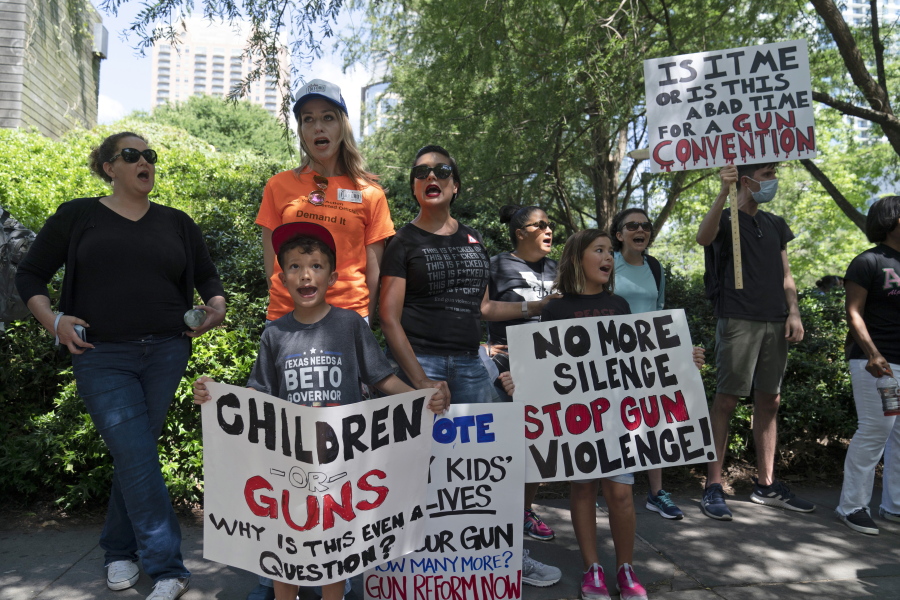 FILE - Protesters chant slogans outside the George R. Brown Convention Center to protest the National Rifle Association annual meeting in Houston, May 27, 2022. March for Our Lives and other gun control groups plan to mobilize supporters on June 11, 2022, to push Congress to require universal background checks, to pass red flag laws allowing guns to be confiscated in certain cases and to raise the age limit to purchase certain guns after recent mass shootings. (AP Photo/Jae C.