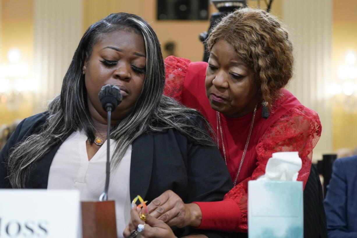 Wandrea "Shaye" Moss, a former Georgia election worker, is comforted by her mother, Ruby Freeman, right, as the House select committee investigating the Jan. 6 attack on the U.S. Capitol continues to reveal its findings of a year-long investigation, at the Capitol in Washington, Tuesday, June 21, 2022. The mother and daughter who were election workers in Georgia brought the sense of danger into stark relief. They testified they feared even to say their names in public after Trump wrongly accused them of voter fraud.