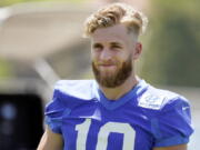 Los Angeles Rams wide receiver Cooper Kupp smiles during stretching at the NFL football team's practice facility, Thursday, May 26, 2022, in Thousand Oaks, Calif.