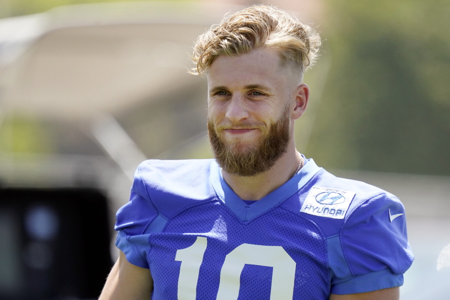 Los Angeles Rams wide receiver Cooper Kupp smiles during stretching at the NFL football team's practice facility, Thursday, May 26, 2022, in Thousand Oaks, Calif.