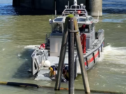 Crews from a Vancouver Fire Department fireboat rescue a man from the Columbia River on Monday afternoon.