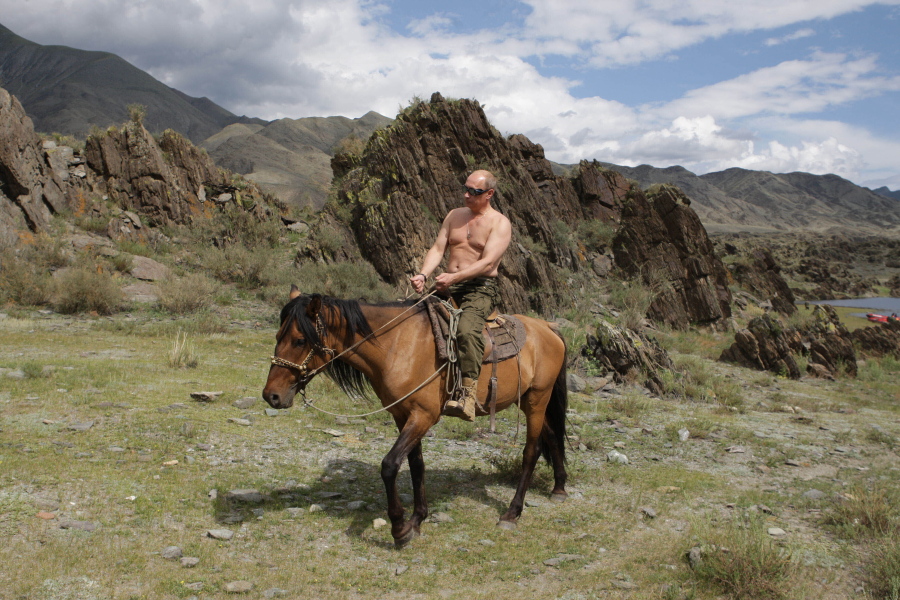 FILE - Then Russian Prime Minister Vladimir Putin rides a horse while traveling in the mountains of the Siberian Tyva region (also referred to as Tuva), Russia, Aug. 3, 2009. Putin has shot back at Western leaders who mocked his athletic exploits, saying they would look "disgusting" if they tried to emulate his bare-torso appearances. Putin made the comment during a visit to Turkmenistan early Thursday, June 30, 2022 when asked about Western leaders joking about him at the G-7 summit.